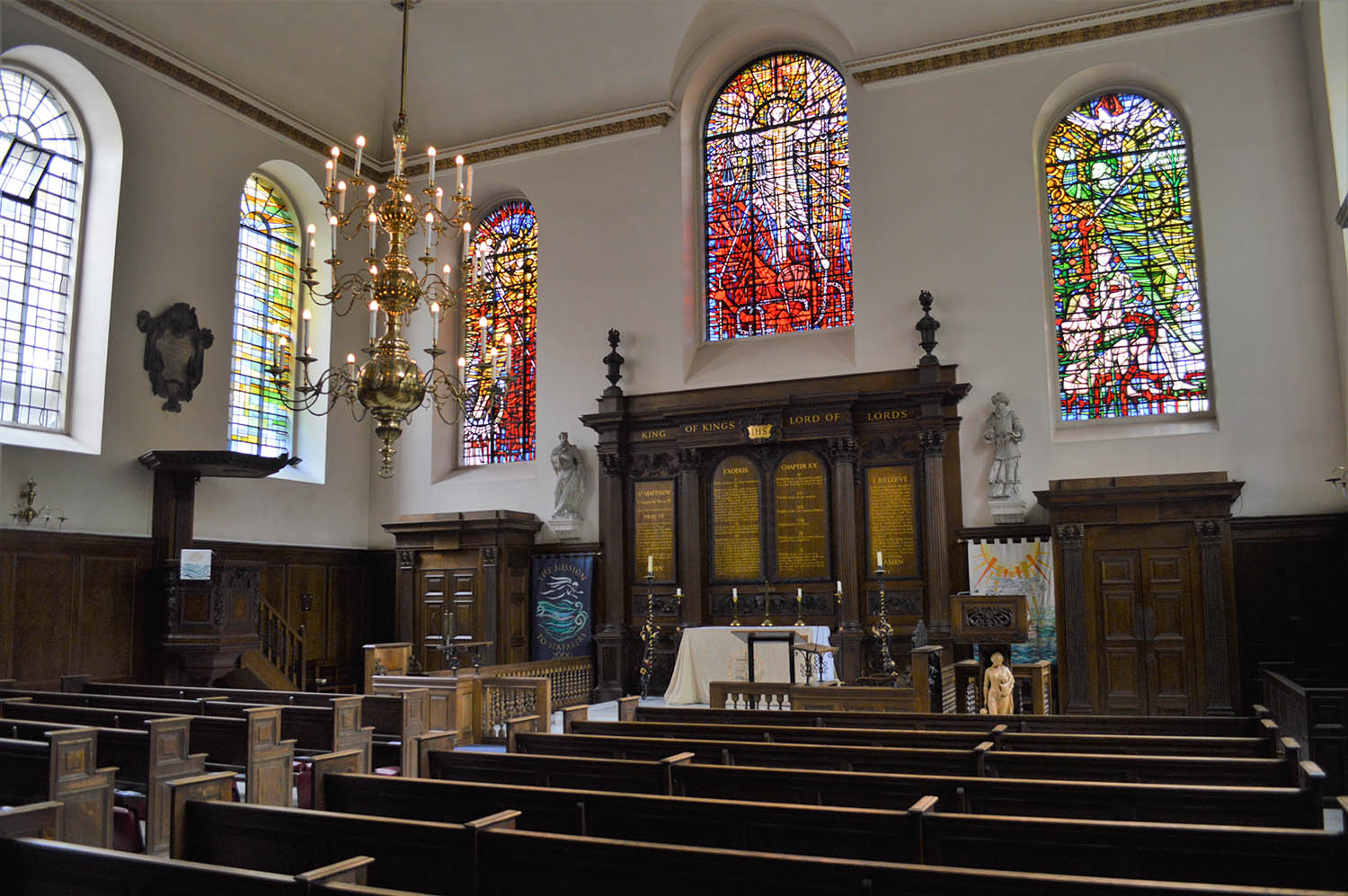 Inside St Michael Paternoster Royal with a view the of stained glass windows