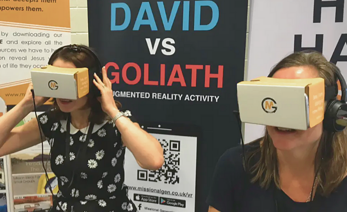 Two women using virtual reality headsets provided by Missional Generation