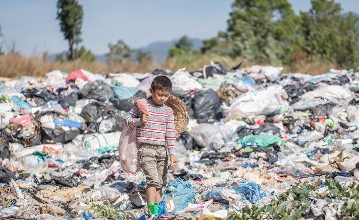 child walking on rubbish
