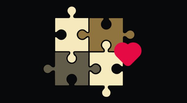 Four jigsaw puzzle pieces with a red heart